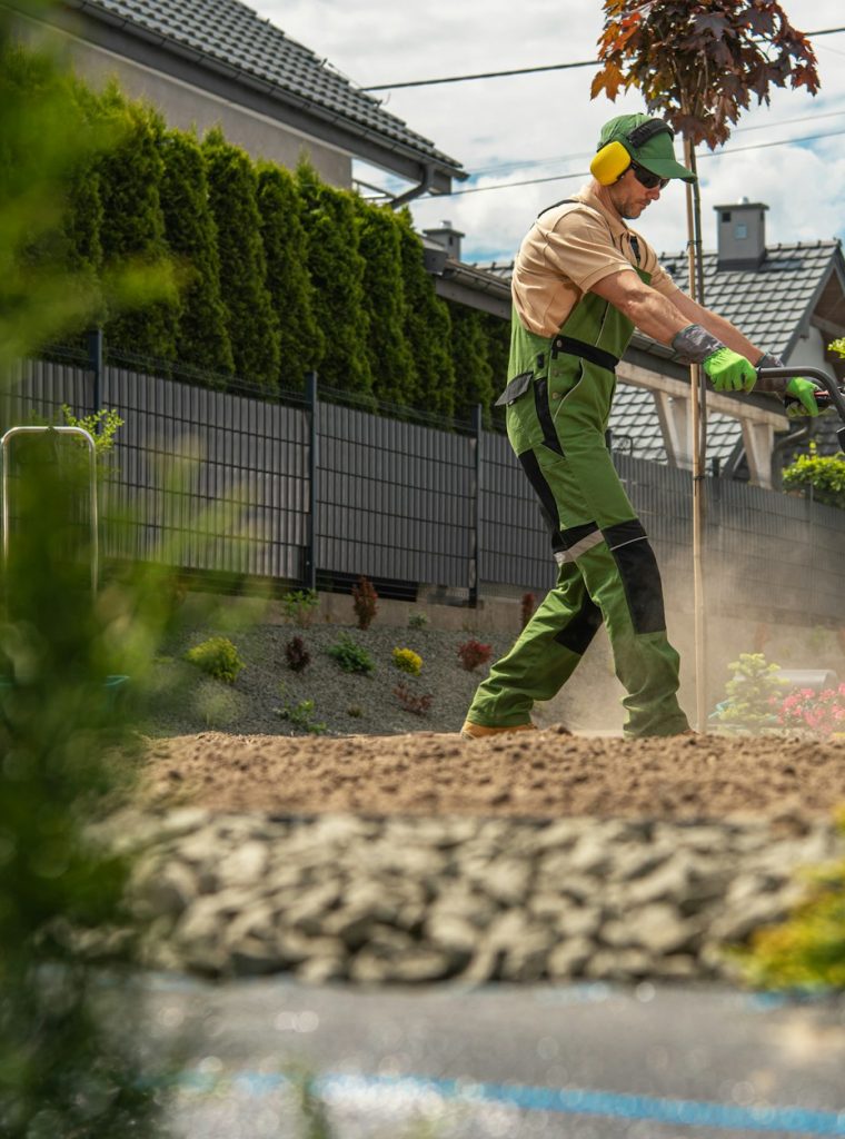 Modern Landscaper Preparing Backyard Soil